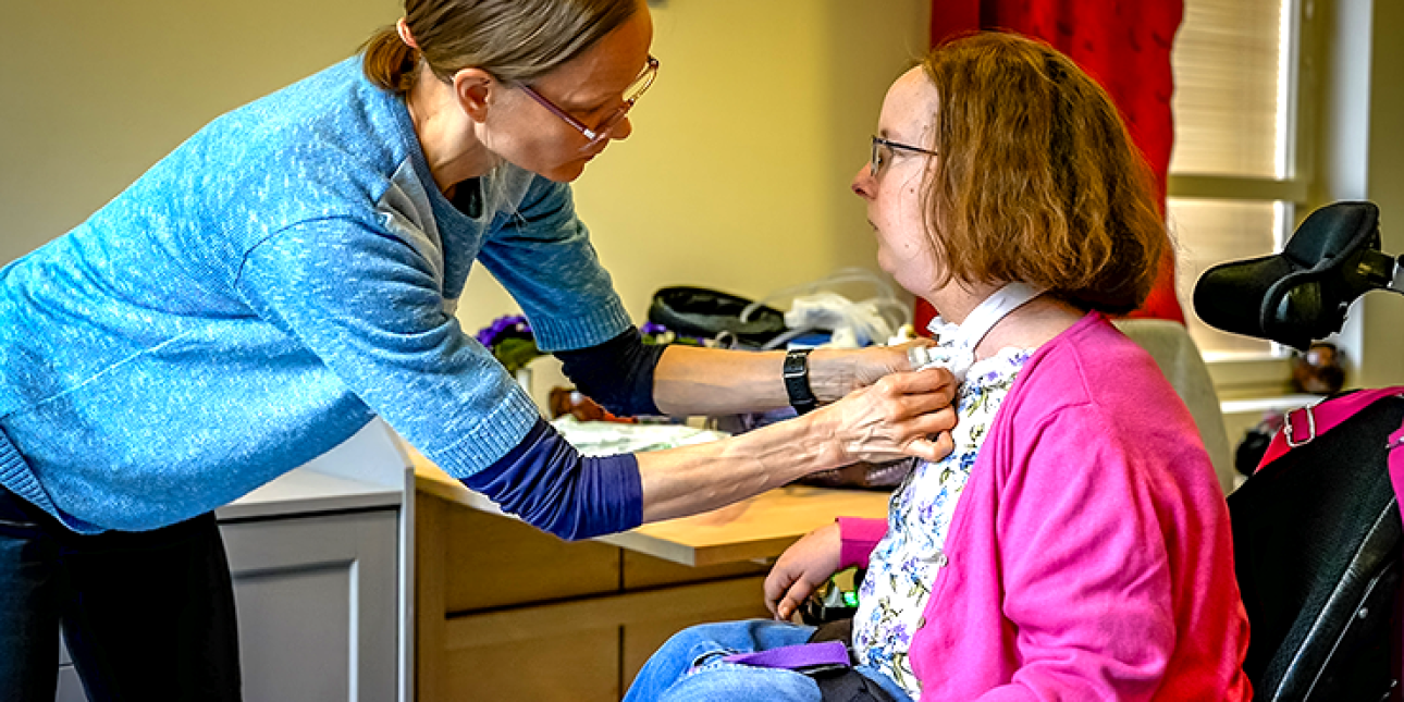 henkilökohtainen avustaja ja nainen pyörätuolissa