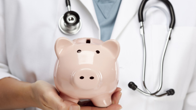 Kuva lääkäristä, jolla kädessä säästöpossu